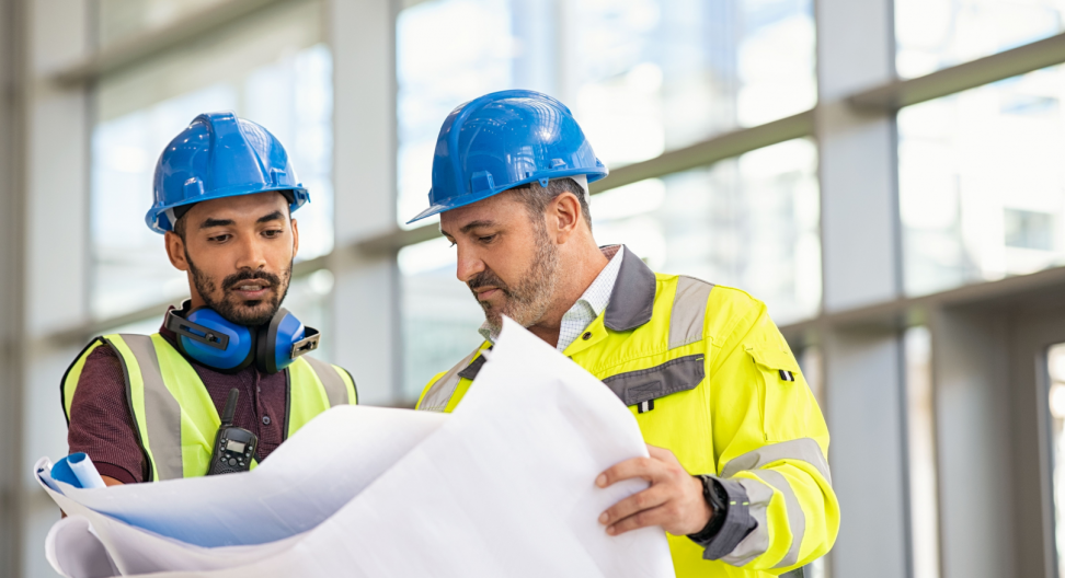 Two construction supervisors looking at blueprints